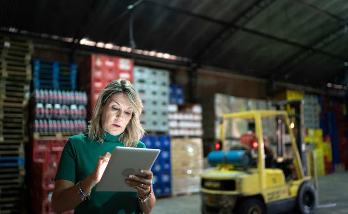 A female employee reviews information on her automated inventory management system.