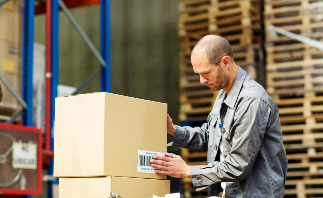 An employee uses barcodes to manage manufacturing inventory