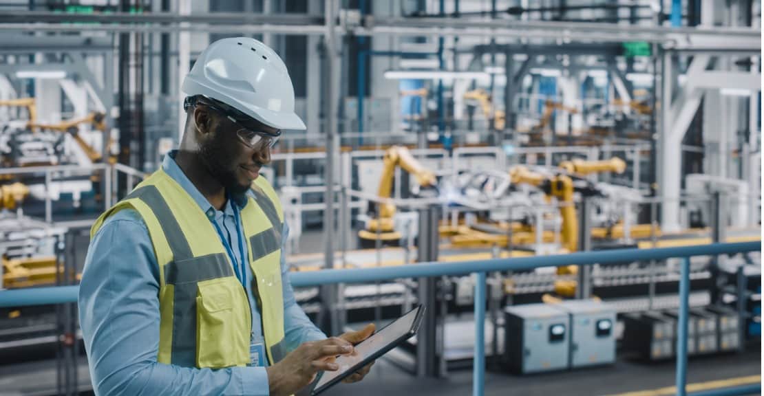 A man takes inventory in a manufacturing plant.